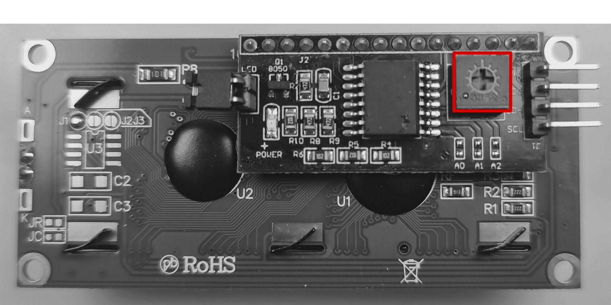 Small I2C LCD backpack on the rear of an LCD module. The contrast potentiometer is highlighted with a red box on the right side.